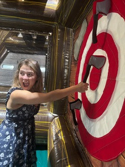 https://ajassets.nyc3.cdn.digitaloceanspaces.com/AJ-COM/products/thumbs/tiny_800_356_Baltimore_Inflatable_Axe_Throwing_Cute_young_woman_with_bullseye.jpg